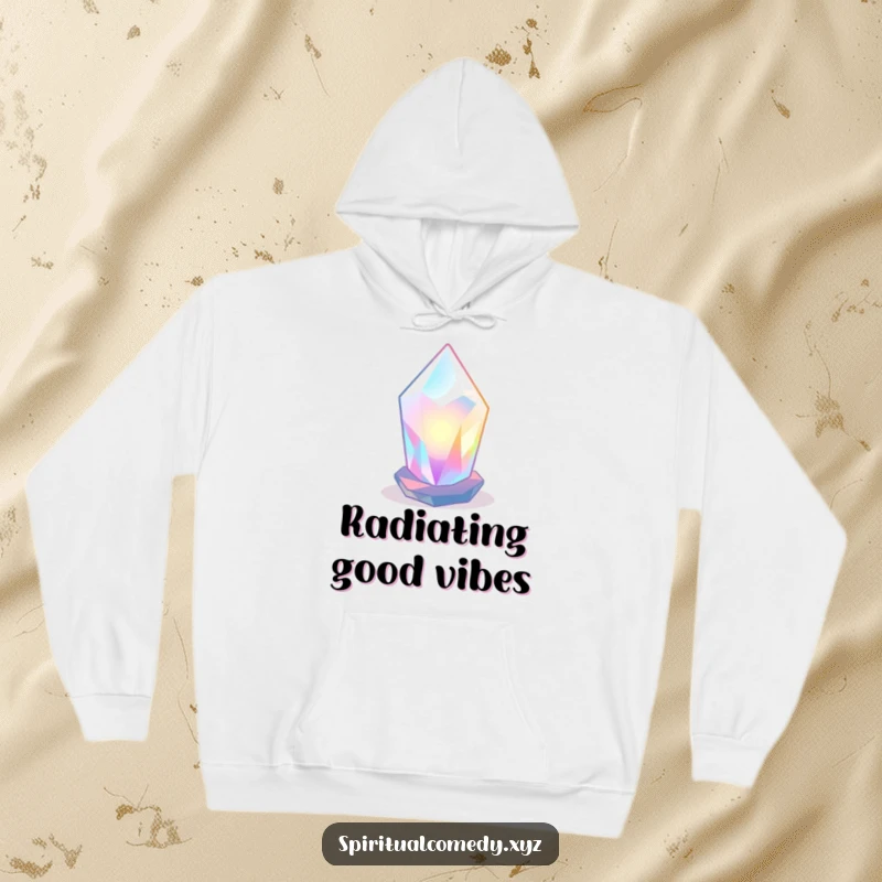 Funny hoodie featuring a stylized, luminous crystal radiating soft colored light in a tranquil space, offering cozy zen humor.